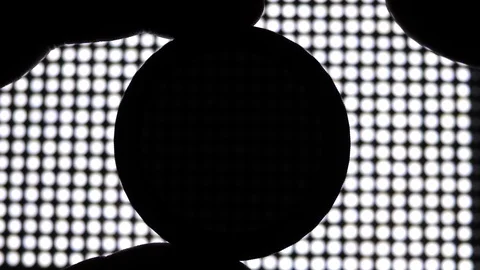 Photographer using Neutral Density variable ND Filter. LED Light in background Stock-Footage 119162032