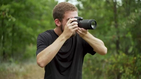 Photographer Walking Through Forest Taking Pictures Video stock 136783584