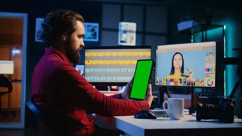 Photographer watches tutorial on mockup tablet to learn how to professionally Stock Photos