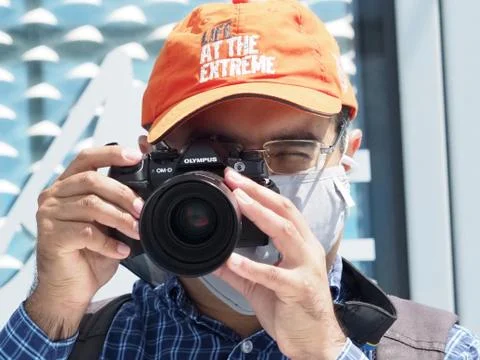 Photographer, Wearing A Mask, Taking A Picture With A Camera Stock Photos