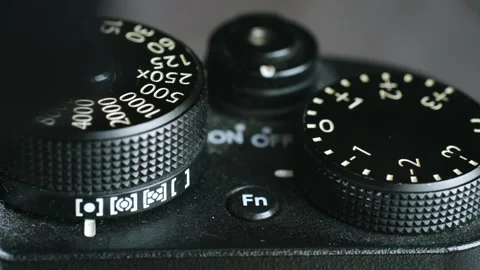 Photographer wipes down professional camera with soft brush Stock Footage 282994940