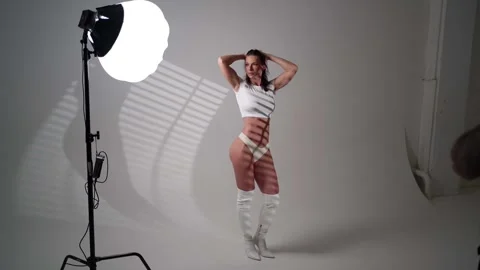 Photographer at work The model poses gracefully in front of the camera  Video stock 301311376
