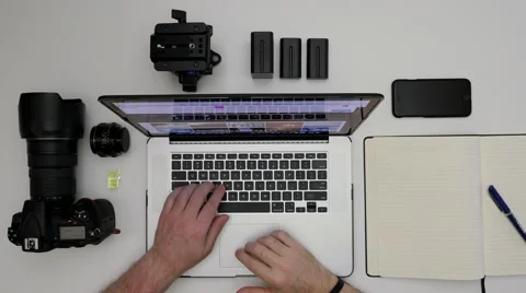 Photographer working on computer (overhead) Stock Footage 64689998