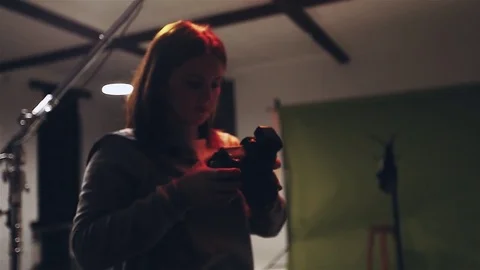 Photographer working process in low light photosession with camera woman Stock Footage 85438156