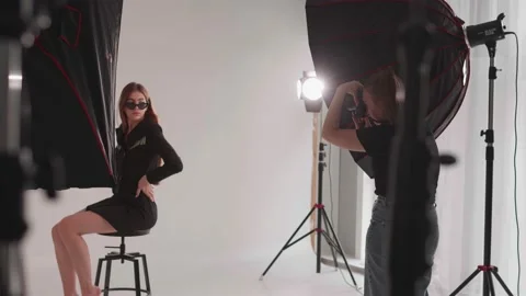 Photographer working in the studio with a model Stock Footage 171758510