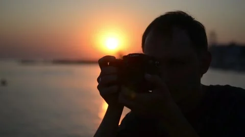 Photographer working at sunset on the beach Stock Footage 53140963