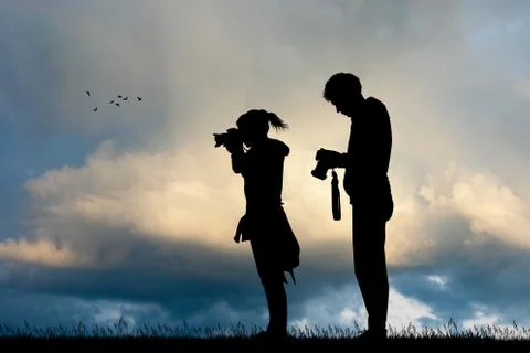Photographers at sunset Stock Illustration