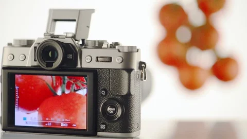 Photographing a tomato on a mirrorless camera on a white background. Stock Footage 97982200
