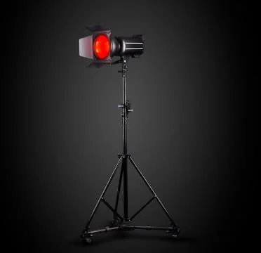 Photography studio flash on a lighting stand isolated on black background. Stock Photos