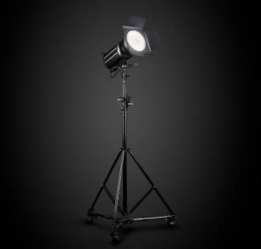 Photography studio flash on a lighting stand isolated on black background. Foto stock