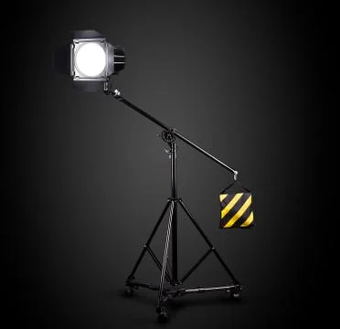 Photography studio flash on a lighting stand isolated on black background. Foto stock