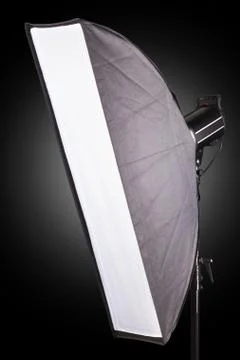Photography studio flash with softbox isolated on black background with lamp. Stock Photos