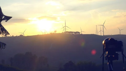 Photography sunset,  Windmill or wind turbine on sunset on mountain golden sky  Stock Footage 95135189