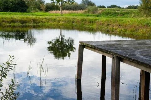 Photos of a small pond between fields in northern Germany with  a relatively  Stock Photos