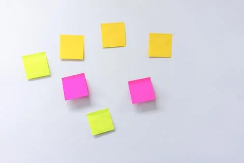 Photos of various colored notepad on a white board Stock Photos