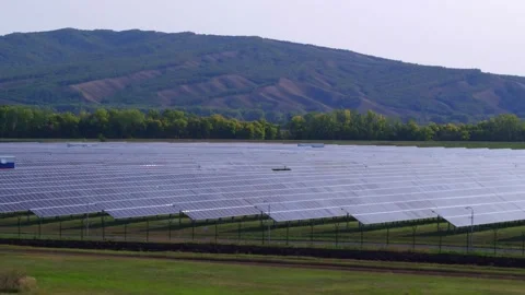 Photovoltaic modules on the backdrop of the slopes of the mountains at dawn. The Stock Footage 156282213