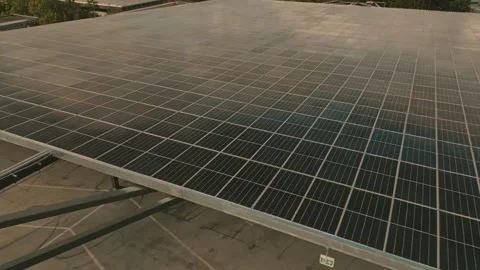 Photovoltaic panel array stretching toward distant clouds filmed by low Stock-Footage 334012567