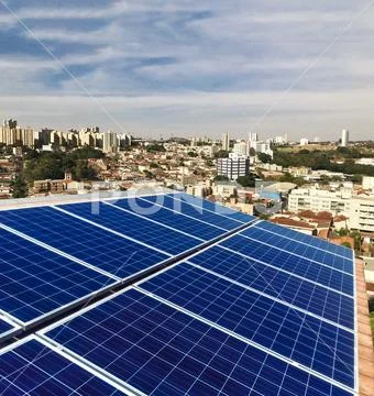 Photovoltaic power plant on the roof of a residential building on sunny day - Stock Photos