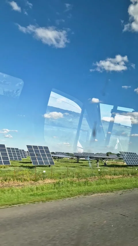 Photovoltaic Solar Farm Array in Green Field Under Sunny Blue Sky Video stock 339085261