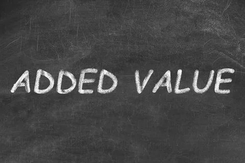 Phrase ADDED VALUE written on black chalkboard 写真素材