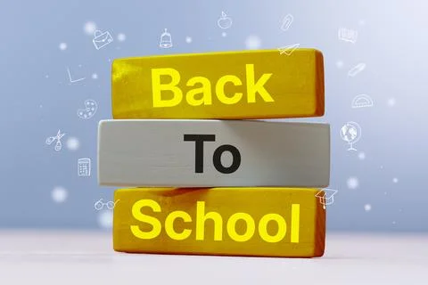 Phrase Back To School written on a stack of yellow and grey wooden cubes su.. Stockfoto's