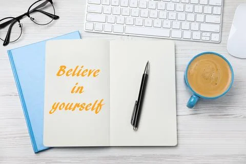Phrase Believe in Yourself in notebook, computer keyboard and cup of coffee.. 스톡 사진