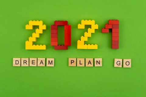 The phrase dream plan do is lined with wooden letters on a green background Stock Photos