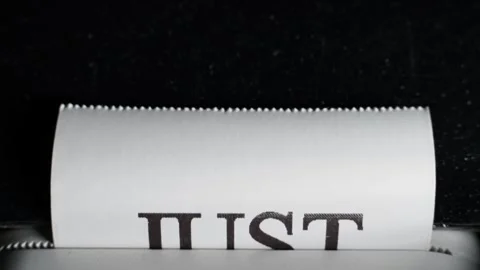 The phrase "just do it" is printed close-up on white paper. Thermal printer Video stock 303497047