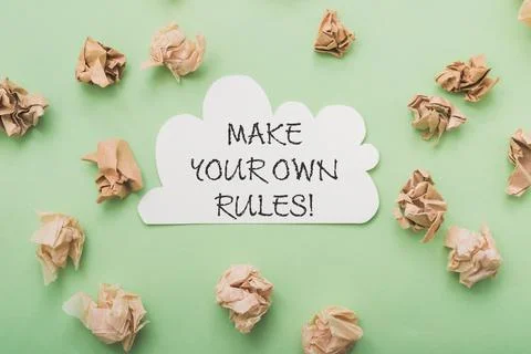 Phrase Make your Own Rules and paper balls on light green Stock-Fotos