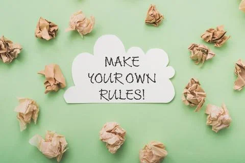 Phrase Make your Own Rules and paper balls on light green Stock Photos
