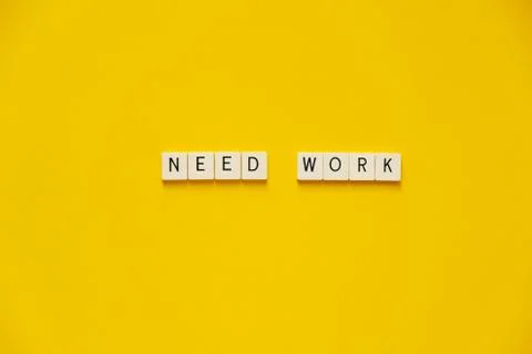 Phrase Need work. Blocks with letters on a yellow background. The concept of job Stock Photos