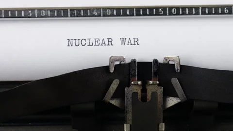 The phrase NUCLEAR WAR is typing on a retro typewriter. Stock-Footage 314581665
