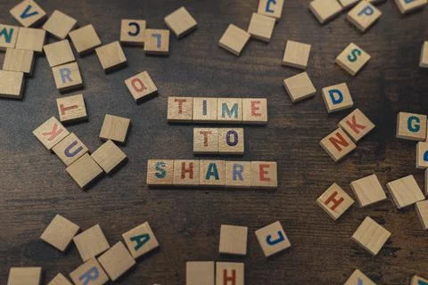 A phrase TIME TO SHARE, made of aligned alphabet blocks with letters donation Stock Photos