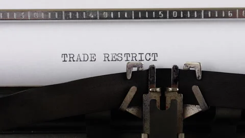 The phrase TRADE RESTRICTIONS is typing on a retro typewriter. Vídeos de archivo 314580977