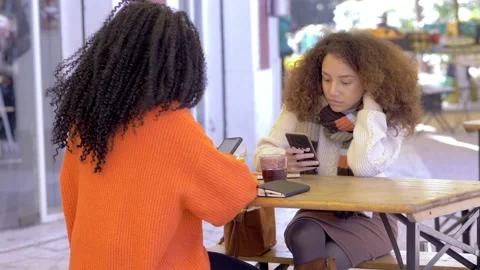 Phubbing concept: two friends at the bar don't talk to each other Video stock 172009017