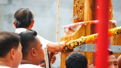 PHUKET, 08 OCT 2018 : Men are tied to the bamboo poles to prepare lifting in  Stock Footage 96142212