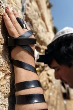 Phylacteries wrapped hand on the western wall Stock Photos