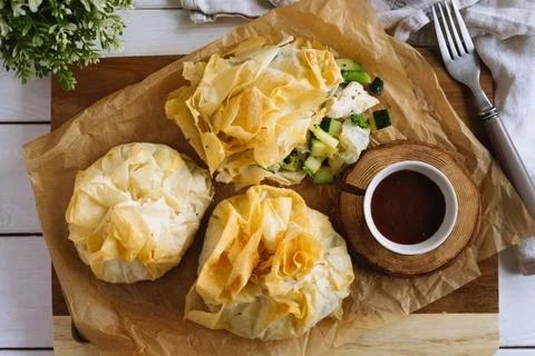 Phyllo Purses. Filo dough filled with chicken and vegetables on parchment Stock Photos