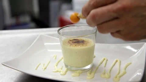 Physalis getting carefully placed on nice caramel dessert. Stock Footage 123394547