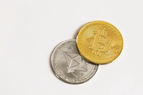 Physical Bitcoin and Ethereum coins on white background. Digital currency, cr Stock Photos