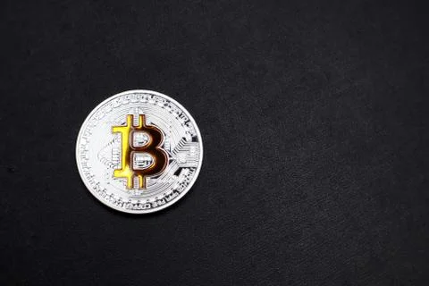 Physical Bitcoin on a black textured background. Stock Illustration