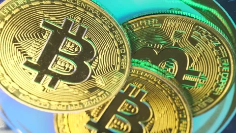 Physical bitcoin cryptocurrency rotating display case in macro shot Stock Footage 265479934
