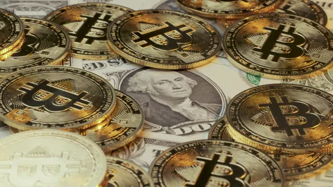 Physical cryptocurrency tokens placed across assorted paper banknotes Stock Footage 334862508