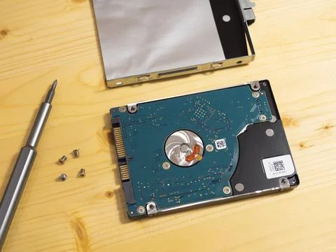 Physical Hard Disk drive being replaced by a solid state flash drive close up 스톡 사진