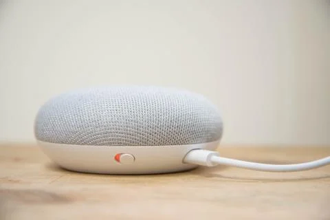Physical microphone switch button of the Google Home Mini Stock Photos