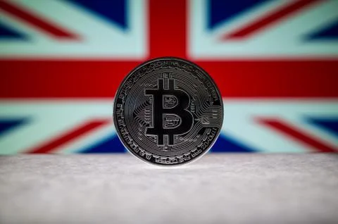 Physical silver version of Bitcoin BTC and United Kingdom Flag on the background Stock Photos