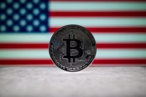 Physical silver version of Bitcoin (BTC) and United States Flag on the Stock Photos