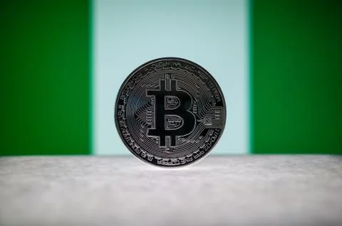 Physical silver version of Bitcoin BTC and Nigeria Flag on the background Stock Photos
