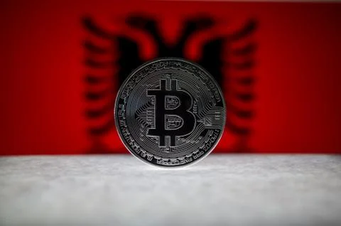 Physical silver version of Bitcoin BTC and Albania Flag on the background Stock Photos
