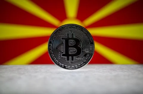 Physical silver version of Bitcoin (BTC) and Macedonia Flag on the background Stock Photos